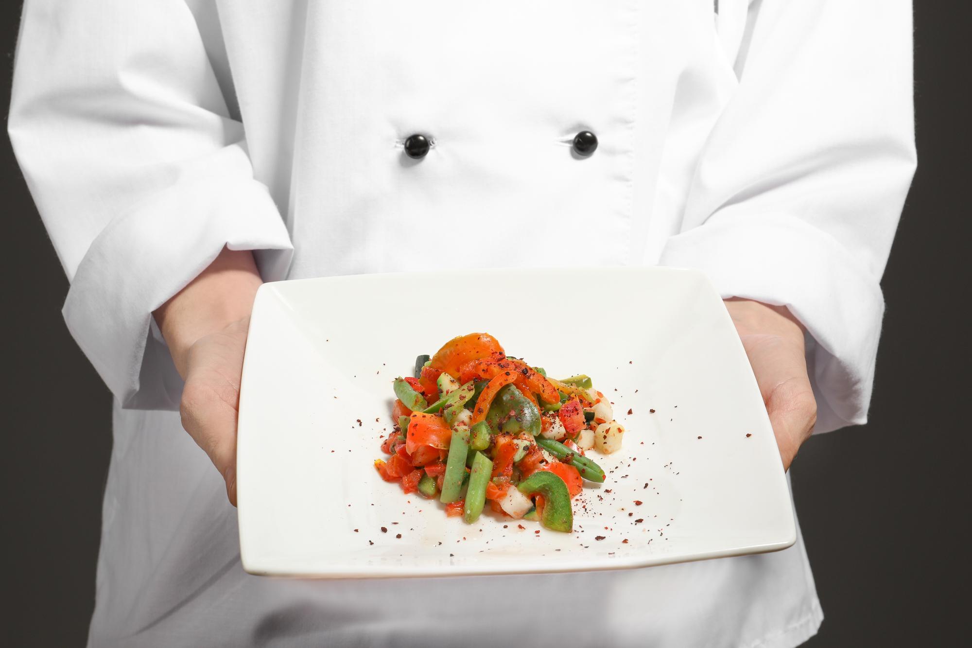 Chef mostra un piatto in primo piano